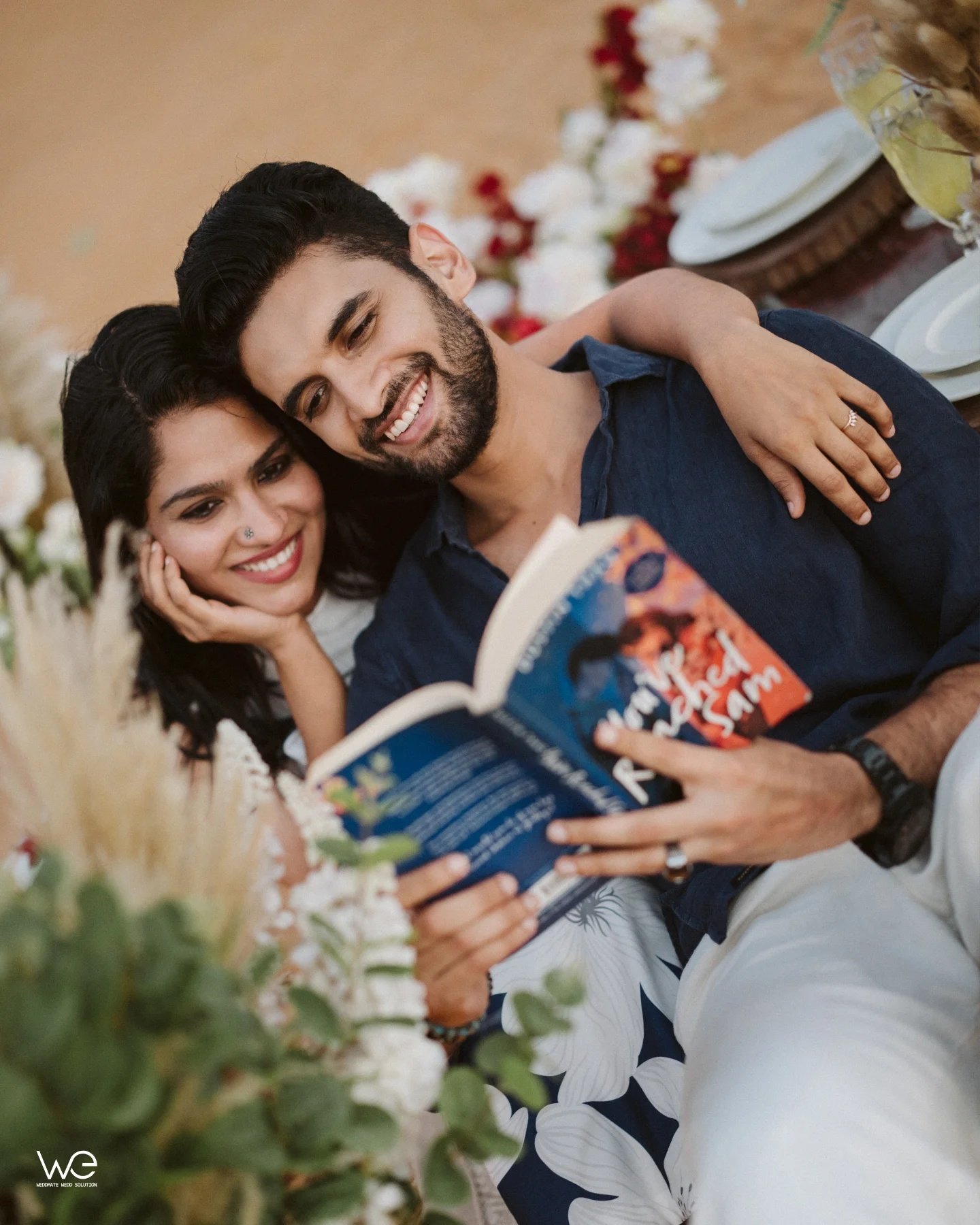 A couple laughing together during a relaxed outdoor picnic